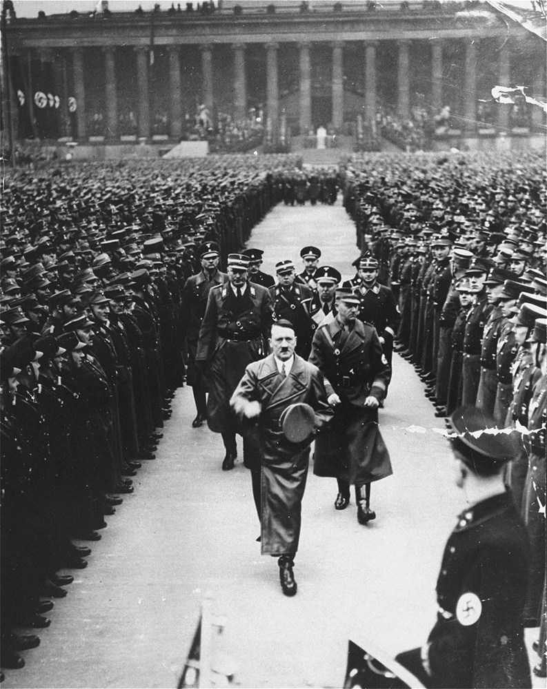 Viktor Lutze accompanies Adolf Hitler on a review of the army in Berlin to commemorate the third anniversary of Hitler's regime